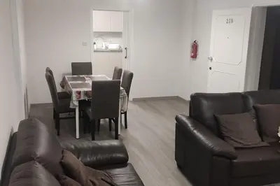 a living room with a table and a leather couch at Tourist Hot Spot Location in Limassol
