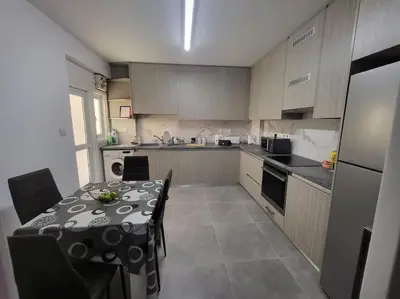a kitchen with a table and a kitchen with a table and chairs at Tourist Hot Spot Location in Limassol
