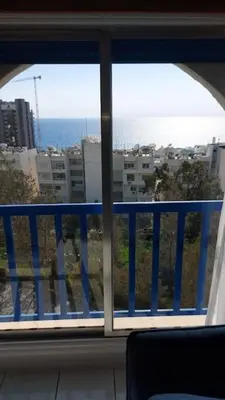 a view of the ocean from a window at Peaceful Beach Location in Limassol
