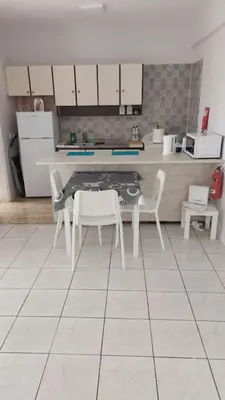 a kitchen with a table and chairs in a room at Peaceful Beach Location in Limassol
