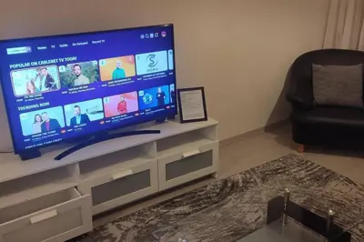 a living room with a large flat screen tv at Balcony Sea View Whole Apt, Minutes To Beach in Limassol