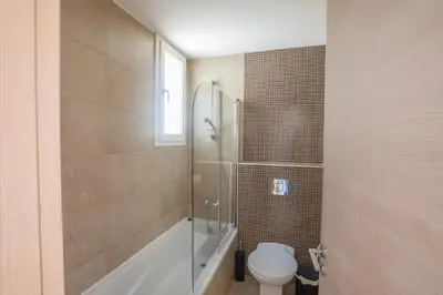a bathroom with a toilet and a tub and a sink at Protaras Katerina Villa Kv53 in Paralimni