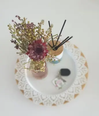 a white plate with two vases with flowers on it at PROTEA RESIDENCE with private terrace in Nicosia