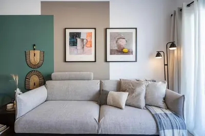 a living room with a couch and pictures on the wall at Hazel - 2-Bedroom Apartment in Larnaca in Larnaka