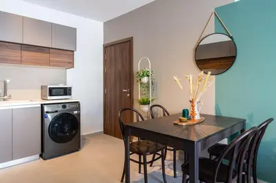 a kitchen and dining room with a table and chairs at Hazel - 2-Bedroom Apartment in Larnaca in Larnaka