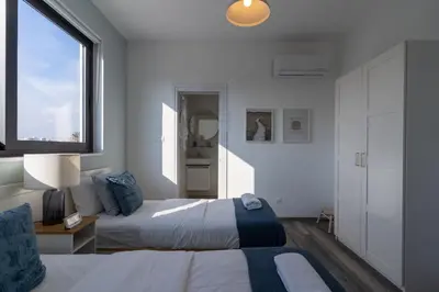 a bedroom with a bed and a large window at Thálassa 2-Bedroom Apartment in Larnaca in Larnaka