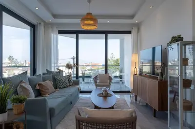 a living room with a couch and a table at Thálassa 2-Bedroom Apartment in Larnaca in Larnaka