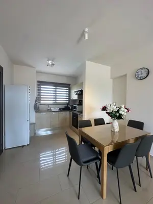 a kitchen and dining room with a table and chairs at Kyklades Resort Excellence in Paralimni