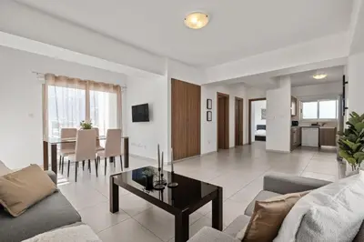 a living room with a couch and a table at Downtown 2 Bedroom Penthouse in Larnaka