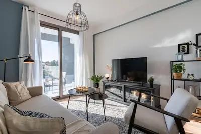 a living room with a couch and a tv at Moon Light 1-Bedroom Apartment in Larnaca in Larnaka