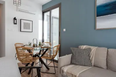 a living room with a table and a couch at Moon Light 1-Bedroom Apartment in Larnaca in Larnaka