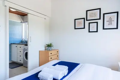 a bedroom with a bed with towels on it at Lazuli Stylish 1-BR Apt W Pool & Balcony in Larnaca in Voroklini