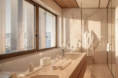 a bathroom with a sink and a glass shower at Amathus Residences in Limassol