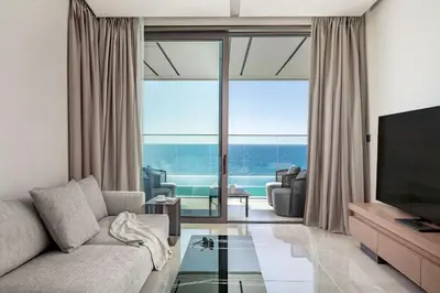 a living room with a couch and a television at Amathus Residences in Limassol