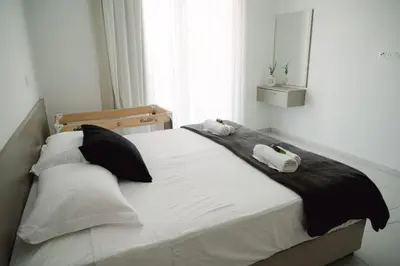 a bedroom with a bed with two towels on it at Nissi Route 76 in Ayia Napa
