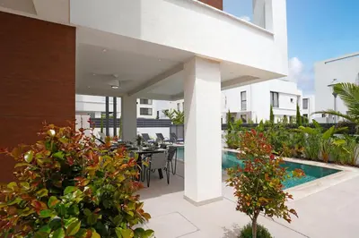 an outdoor patio with a table and chairs and plants at Levanda Platinum - Sunrise Sea View in Protaras
