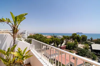 a balcony with a view of the ocean at Blue Penthouse Mackenzie in Larnaka