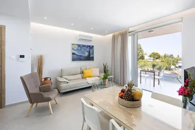 a living room with a couch and a table at Attika Residence in Strovolos