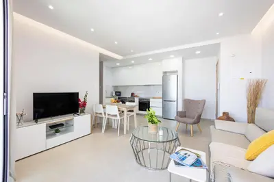 a living room with a couch and a table at Attika Residence in Strovolos