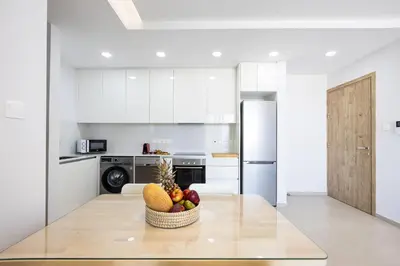 a kitchen with a bowl of fruit on a table at Attika Residence in Strovolos