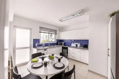 a kitchen with a table and chairs in a room at Luxurious Bright & Stylish 2BR with Office in Nicosia in Nicosia