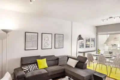 a living room with a couch and a kitchen at Luxurious Bright & Stylish 2BR with Office in Nicosia in Nicosia