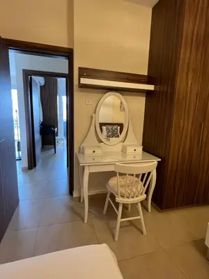 a dressing table with a mirror and a chair at Mythical Sands - Evexia in Paralimni