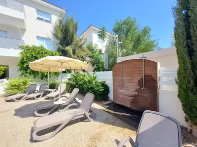 a row of chairs and umbrellas on a patio at Mythical Sands - Evexia in Paralimni
