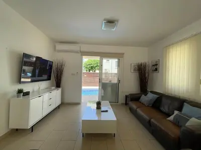 a living room with a couch and a coffee table at 13 Crystal Lagoon Villa in Paralimni
