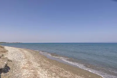 a sandy beach with the ocean in the background at Chelidonia Larnaca Seafront Villa in Meneou