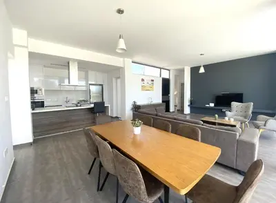 a living room with a table and a couch at NISSI PEARL Holiday Villas Ayia Napa in Ayia Napa