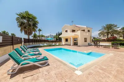a villa with a swimming pool and a house at Villa Sarah in Ayia Napa