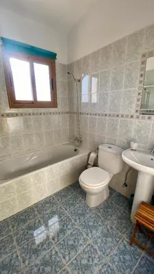 a bathroom with a toilet and a tub and a sink at Villa Annalisarose in Ayia Napa