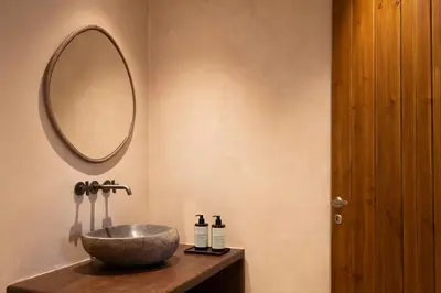 a bathroom with a bowl sink and a mirror at Casa Oliva Guesthouse in Tris Elies