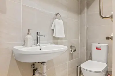 a bathroom with a sink and a toilet at Serenity Waves Villa 12 in Sophtadhes