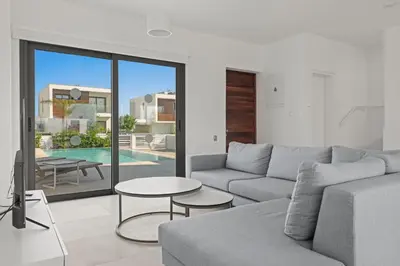 a living room with a couch and a table at Serenity Waves Villa 10 in Sophtadhes