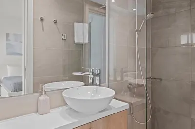 a bathroom with a sink and a glass shower at Serenity Waves Villa 10 in Sophtadhes
