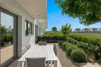 a white table and chairs on a patio at Serenity Waves Villa 10 in Sophtadhes