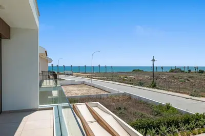 a balcony with a view of the ocean at Serenity Waves Villa 16 in Larnaka