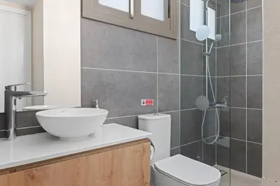 a bathroom with a sink and a toilet and a shower at Serenity Waves Villa 17 in Larnaka