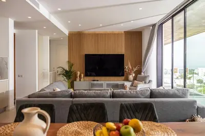 a living room with a couch and a tv at Shanti Tranquil Escapes in Paralimni