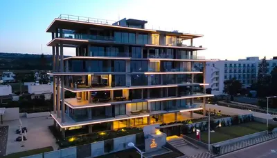 a tall building with lights on in a city at Shanti Tranquil Escapes in Paralimni