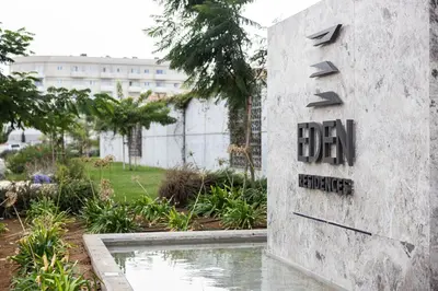 a sign on the side of a building with a pond at Shanti Tranquil Escapes in Paralimni