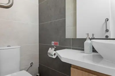 a bathroom with a white sink and a toilet at Serenity Waves Villa 26 in Larnaka