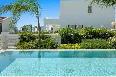 a swimming pool in front of a villa at Serenity Waves Villa 26 in Larnaka
