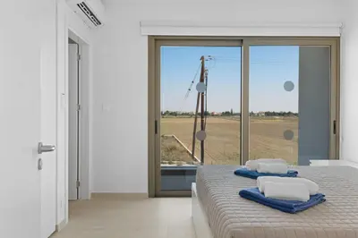 a bedroom with a bed with towels on it at Serenity Waves Villa 26 in Larnaka