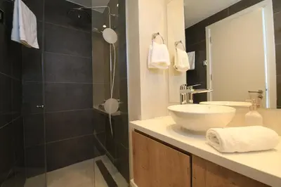 a bathroom with a sink and a shower at Serenity Waves Villa 27 in Sophtadhes