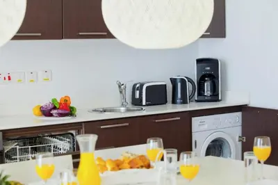 a kitchen with a table with glasses of orange juice at Dazzling Protaras Villa Villa Akame 3 Bedrooms Beachfront in Protaras