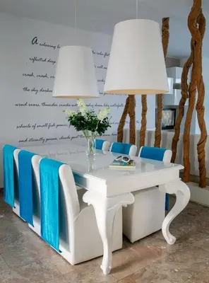 a white table with blue chairs and two lamps at Exquisite Protaras Villa Villa Bulat 4 Bedrooms Beachfront in Protaras