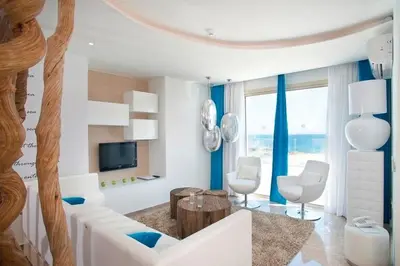 a living room with a white couch and a table at Exquisite Protaras Villa Villa Bulat 4 Bedrooms Beachfront in Protaras